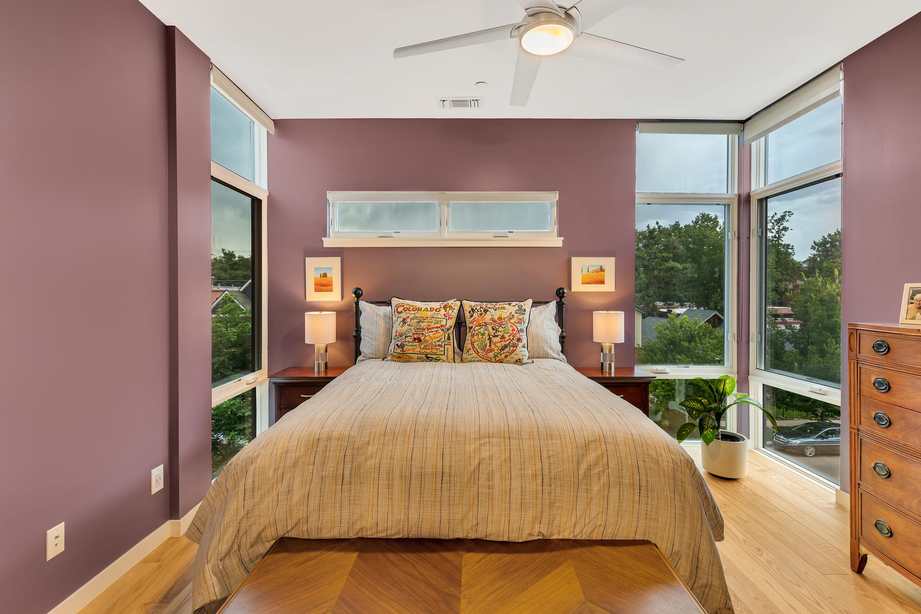 master bedroom in condo with floor to ceiling windows