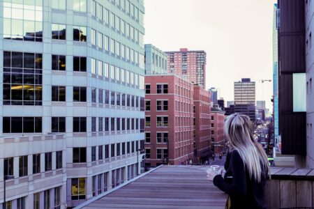 woman looking at buildings from a rooftop